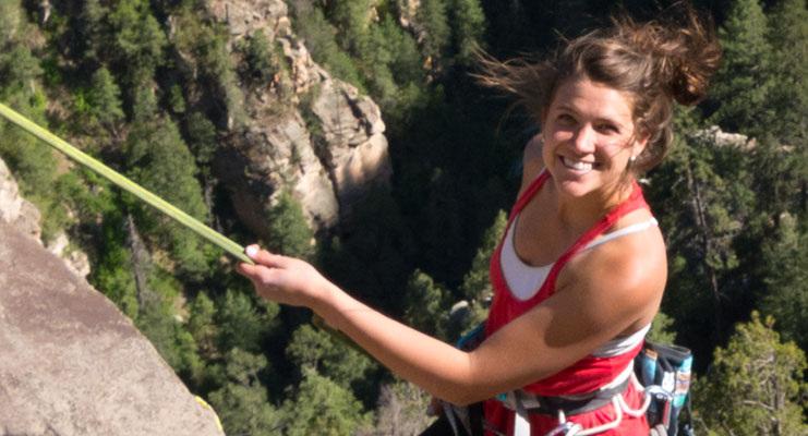 woman posing while rock climbing