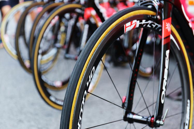 Close up of a row of bike tires. The tires are black with a yellow stripe