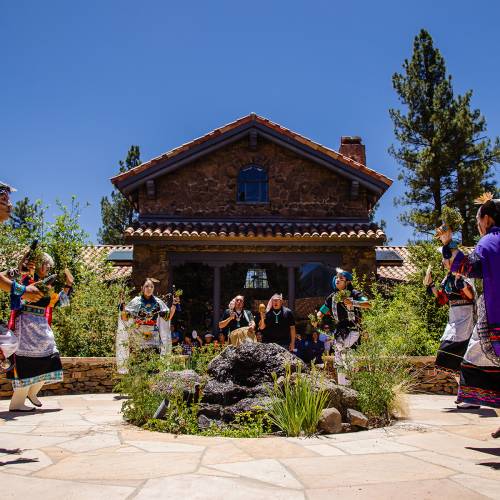 MNA Courtyard during festival with group of Native Americans performing traditional ceremonial dance in Flagstaff AZ