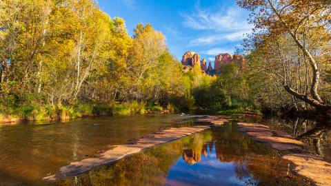 Scenic landscape of Sedona Arizona with trees filled with fall leaves and water