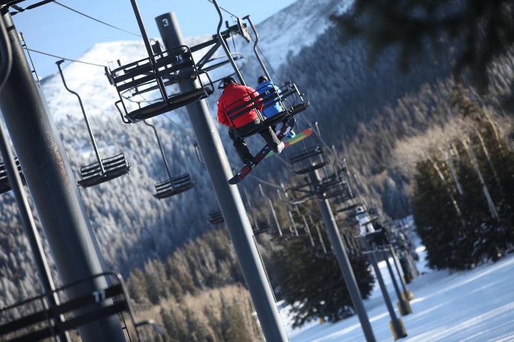 snowboarders on Snowbowl chairlift