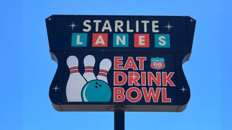 Starlite Lanes sign on Route 66. The sign has an illustration of 3 pins and a bowling ball