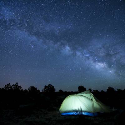 tent camping at night under starry skies