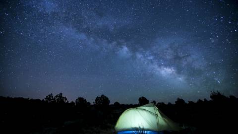 tent camping at night under starry skies