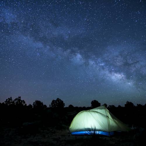 tent camping at night under starry skies